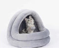 Gray round cat cave bed with cushioned rim and hanging plush ball toy