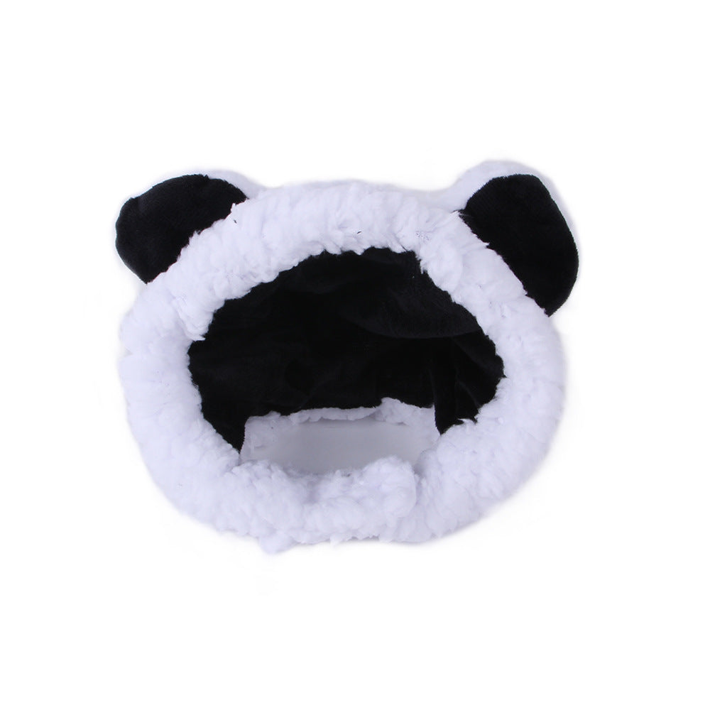 White plush pet hat with black ear accents and a thick fuzzy hood opening