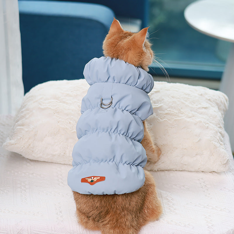 Light blue cotton puffer dog vest with ring buckle strap and snap closure.