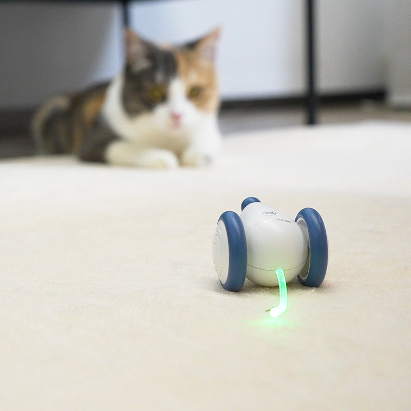 Electric cat mouse toy on sofa, blue and white, glowing green light.