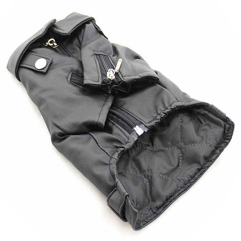 Pet dog jacket laid flat, dark fabric with snap buttons, zippers, and padded cuffs