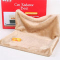 Beige plush cat radiator bed with raised backrest and small toy on the base