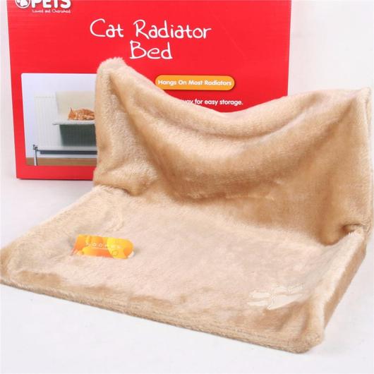 Beige plush cat radiator bed with raised backrest and small toy on the base