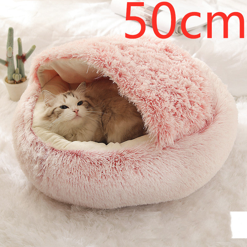 Pink round plush pet bed house with fluffy rim and cozy inner nest for cats and dogs.