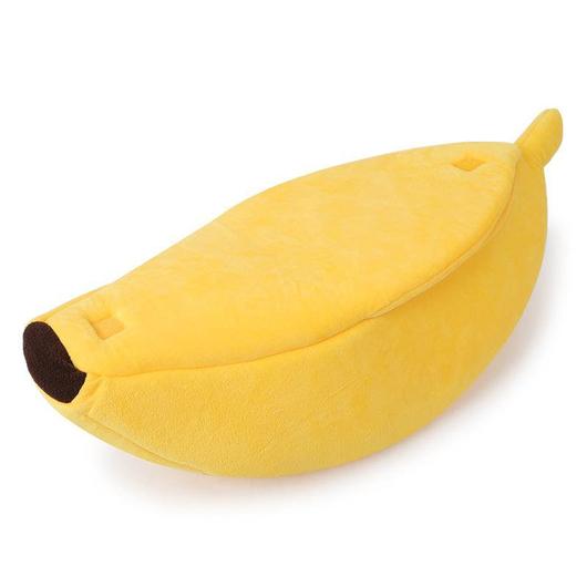 Yellow banana-shaped pet bed with brown end caps and plush sides