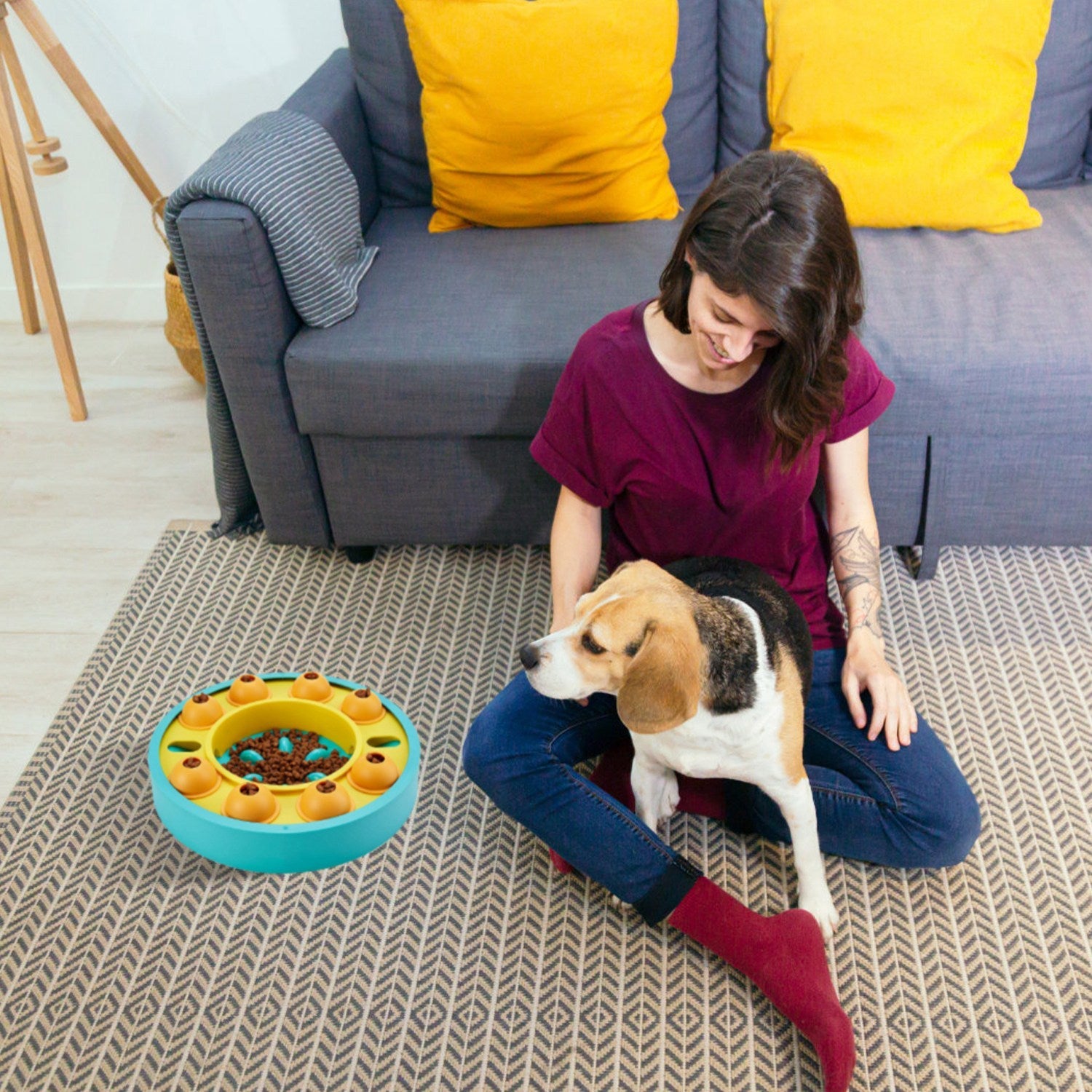 Slow feeding puzzle dog bowl with turquoise outer ring and orange treat pods