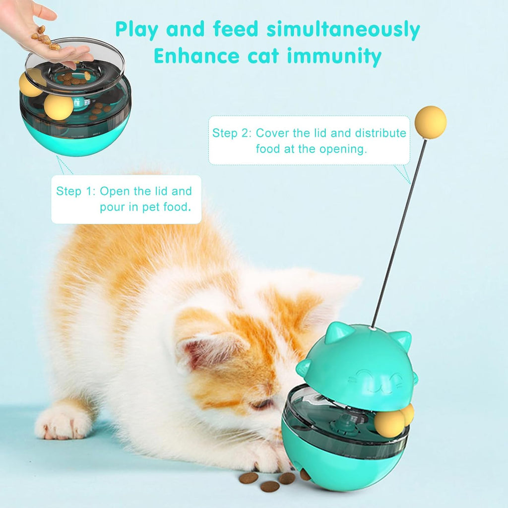 Cat treat dispenser toy in teal with clear bowl and yellow balls, with cat nearby