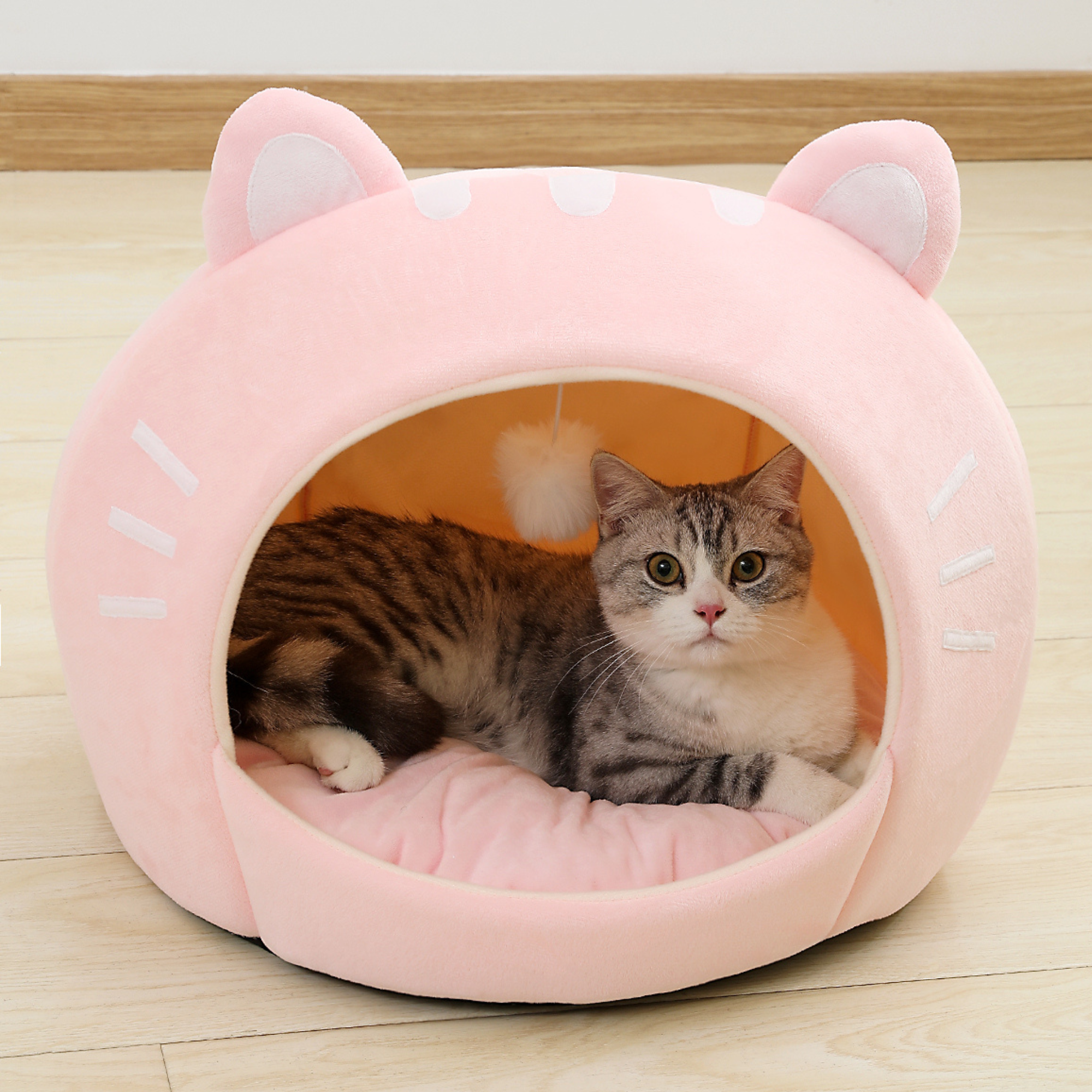 Pink cat-shaped plush pet bed with open round entrance and ear hood