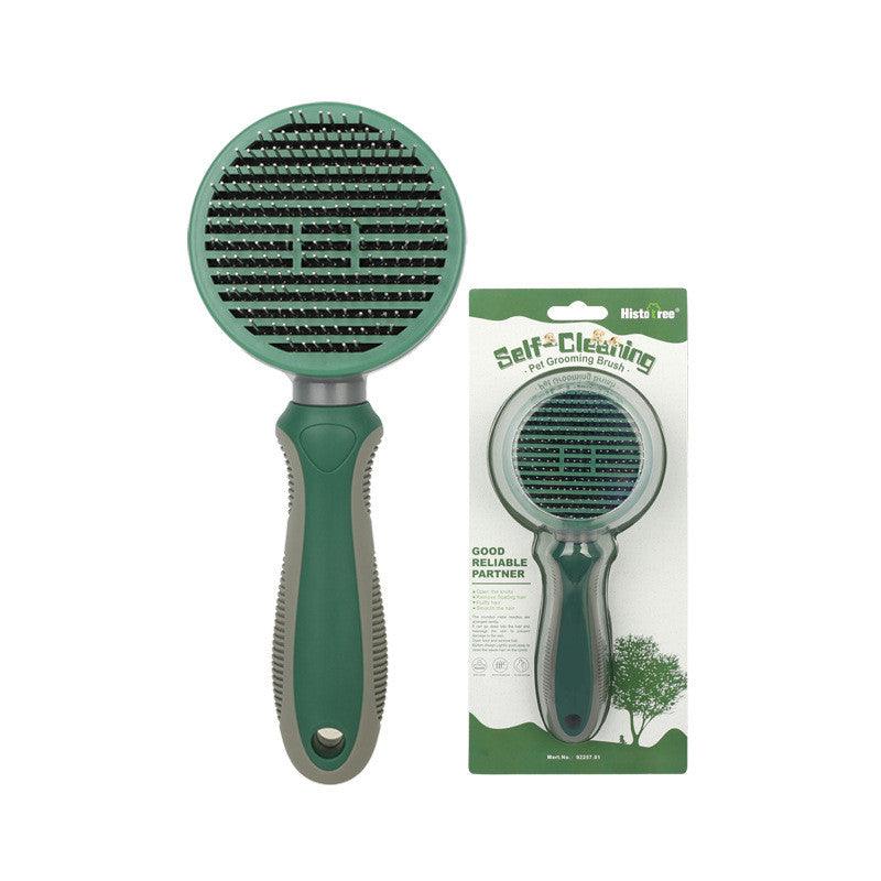 Green pet grooming brush with dense needle rows on round head and ergonomic handle