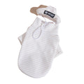 White two-legged pet shirt laid flat, hooded design with drawstring and U C A T tag