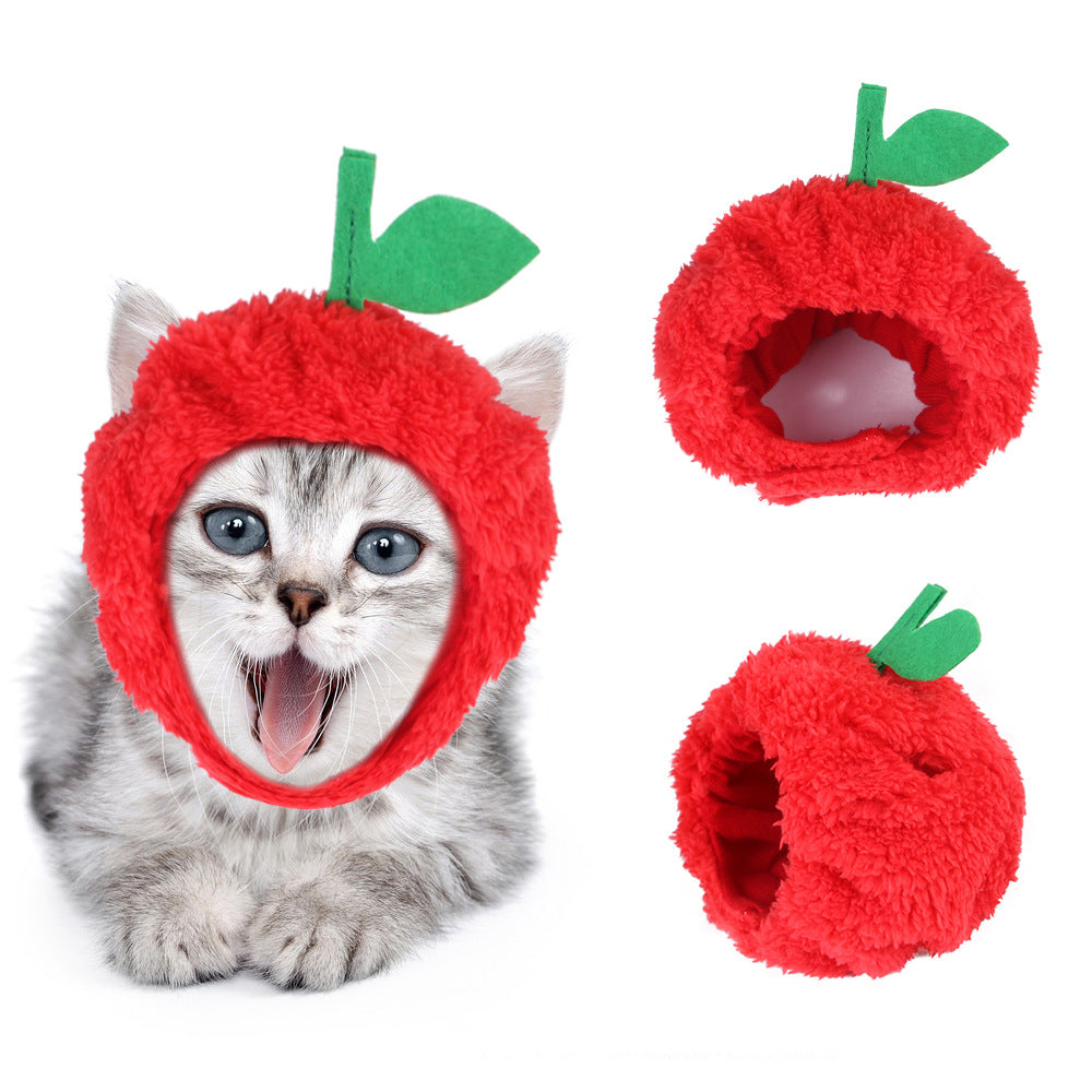 Red fuzzy pet fruit hat with green leaf accents and curled donut-style shape