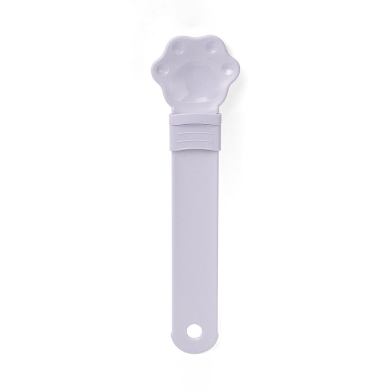Cat treat spoon squeeze with cat-shaped head, purple handle