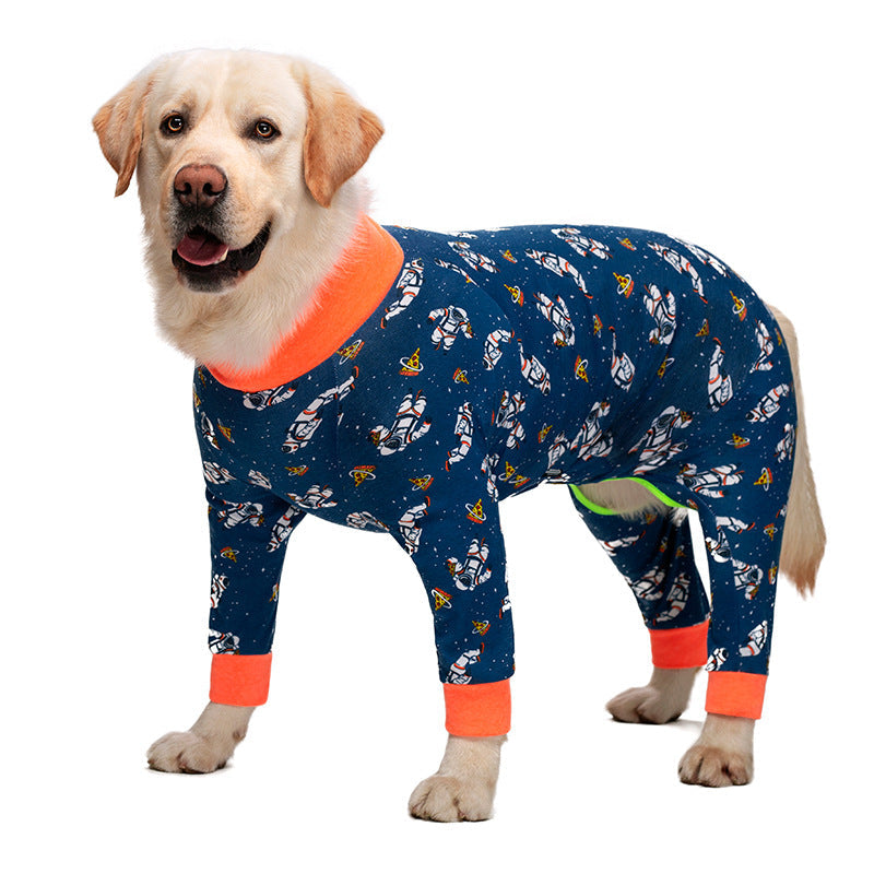 Medium-large dog recovery suit in navy with orange cuffs and playful dinosaur pattern.