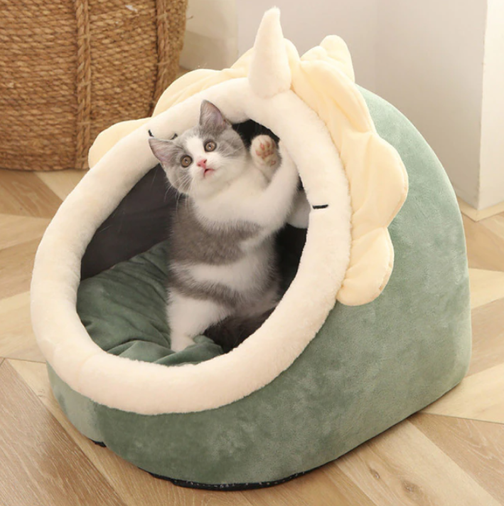Green cat bed with cream rim and plush ear top; enclosed cozy nest for cats