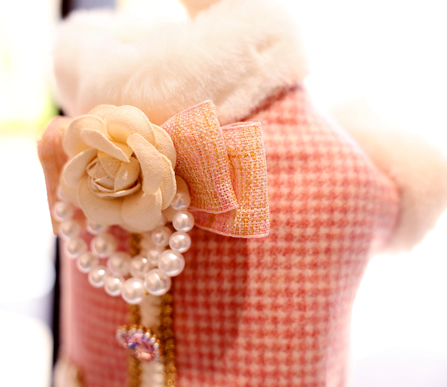 Pink tweed dog coat vest close-up with faux fur collar and pearl bow detail