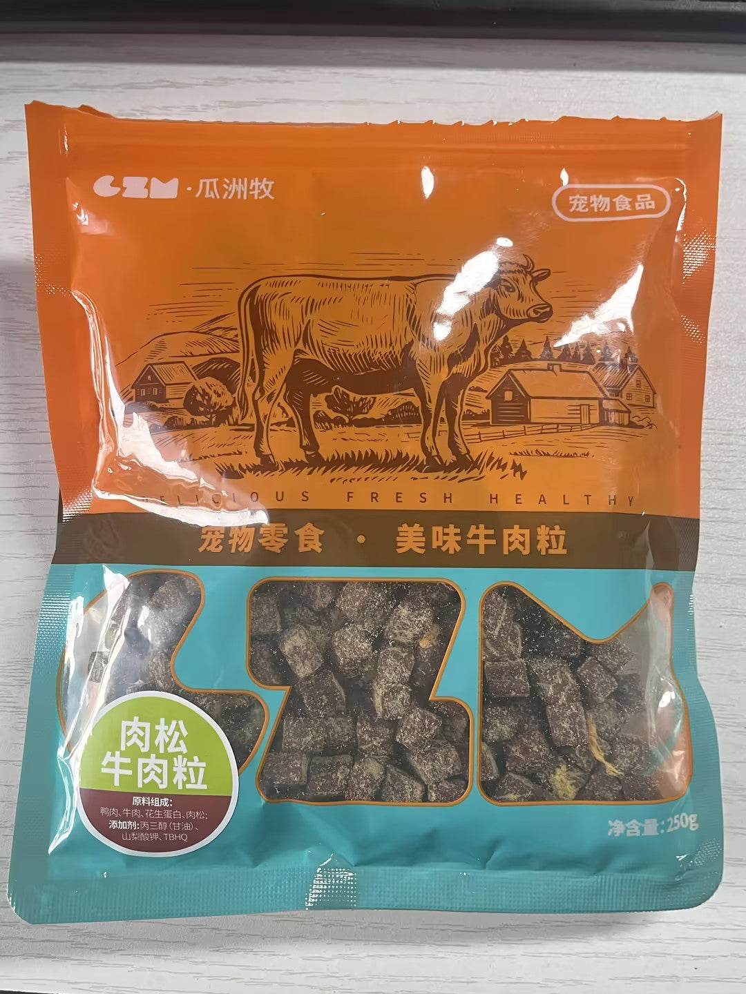 Beef dog treat pouch with orange top, cow illustration, and clear treat window