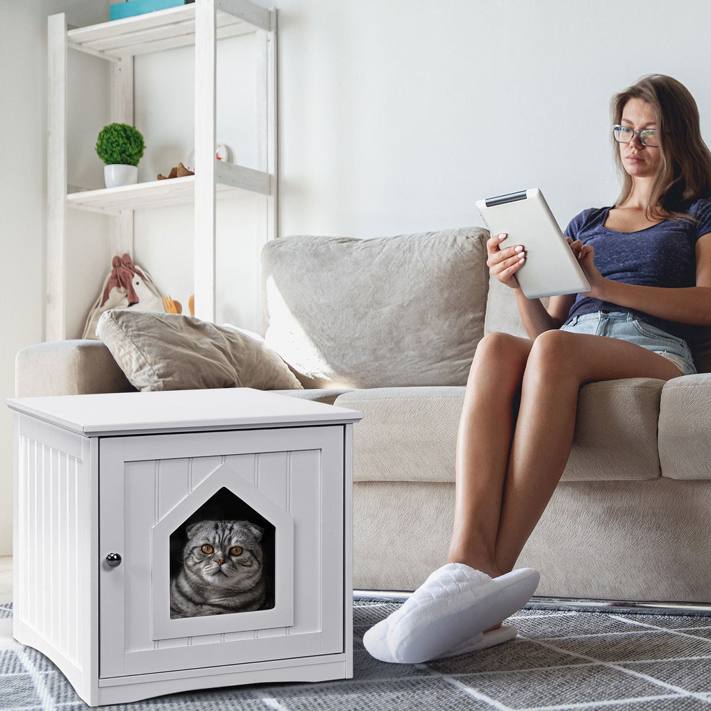 White cat house side table with front door and cat peeking through black opening