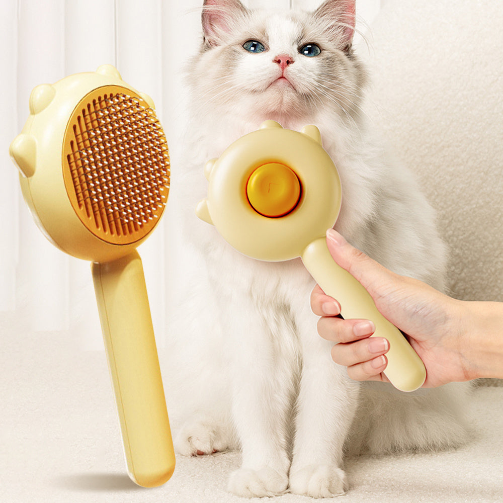 Cat grooming brush with yellow oval slicker head and massage pad handle