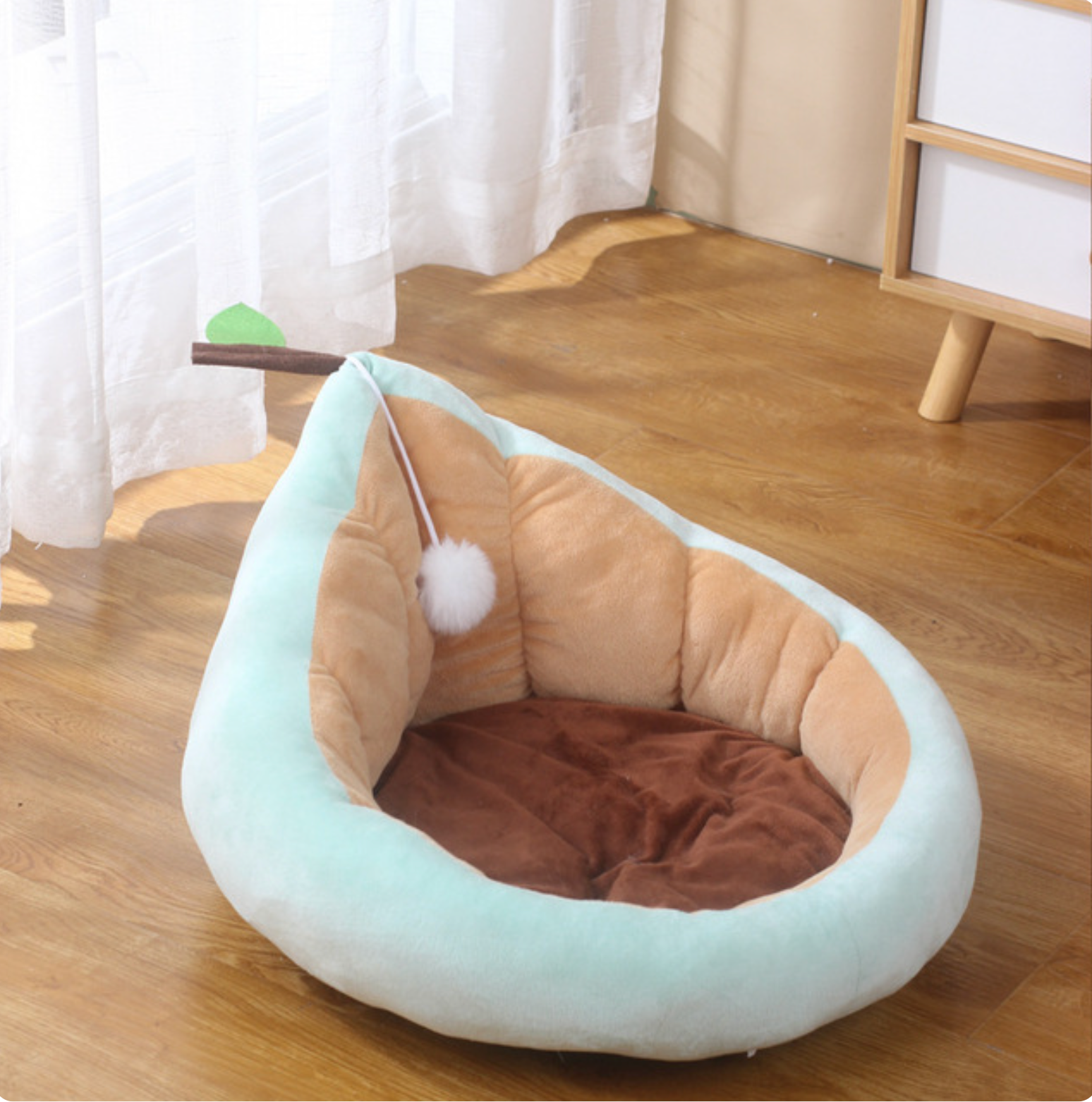 Light blue pear-shaped pet lounger with beige sides and brown plush base