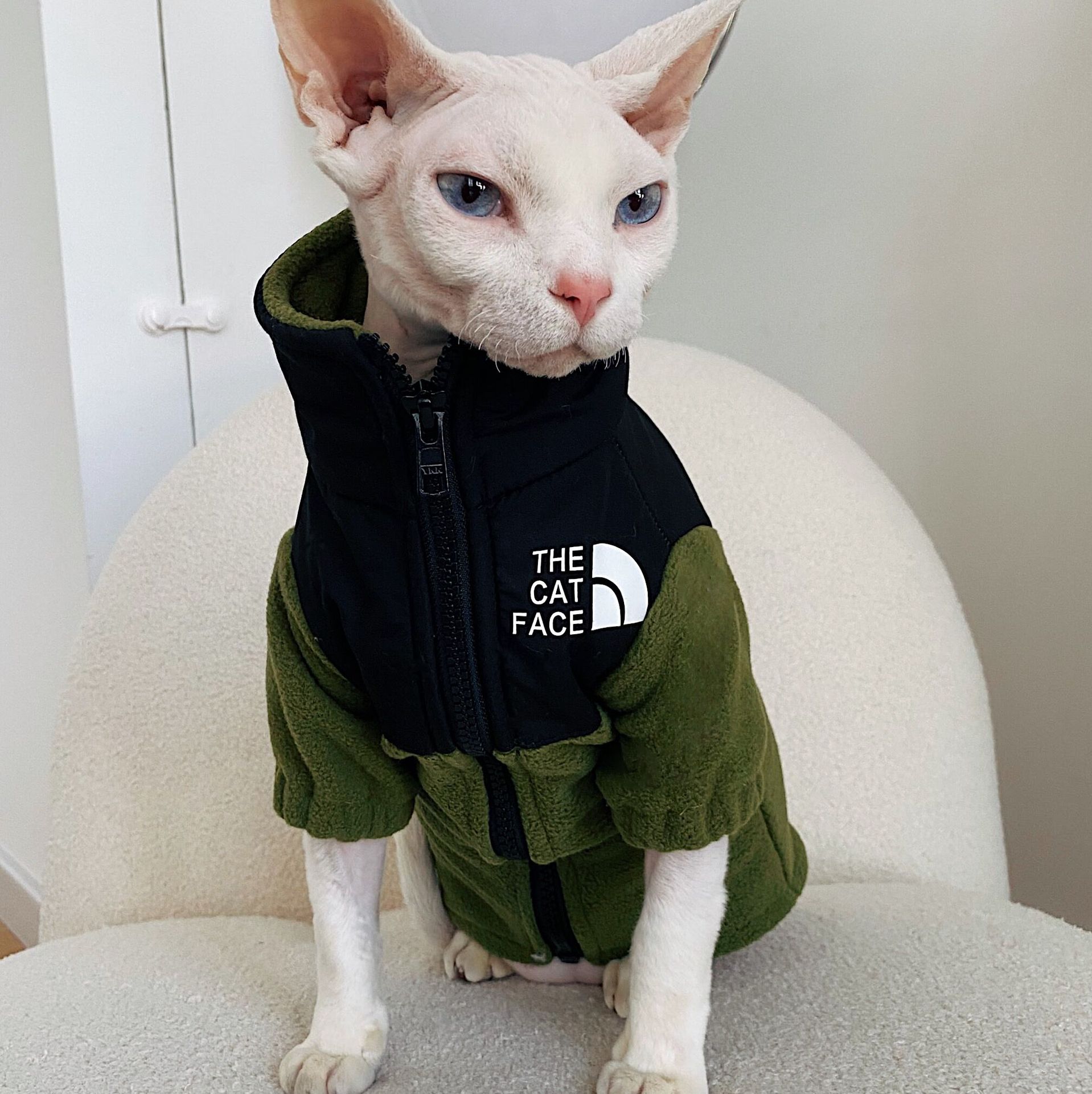 Olive green fleece cat jacket with zipper and hood, 'THE CAT FACE' chest patch.