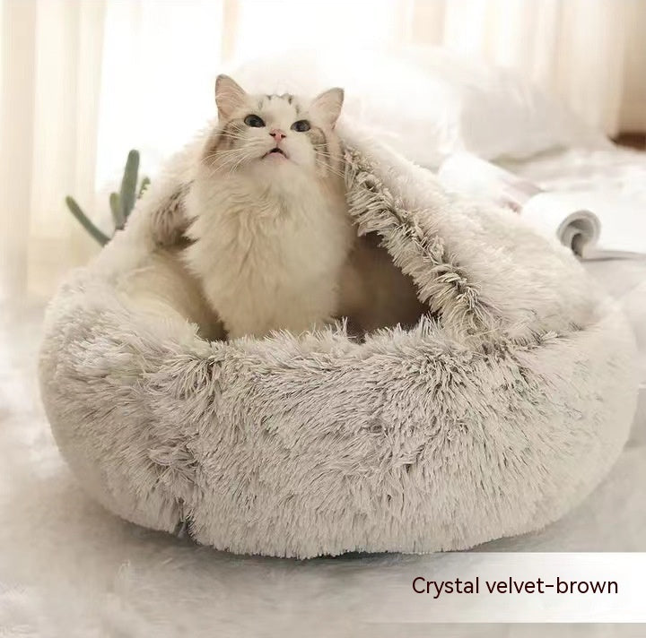 Round plush pet bed in brown with shaggy exterior and front cave opening