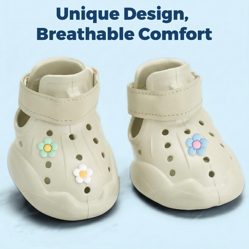 Light beige dog clog booties with perforations, flower accents, and hook-and-loop strap.
