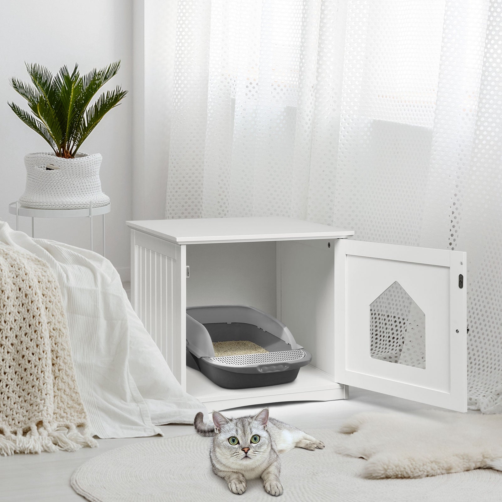White cat house side table with open front door and grey litter tray inside