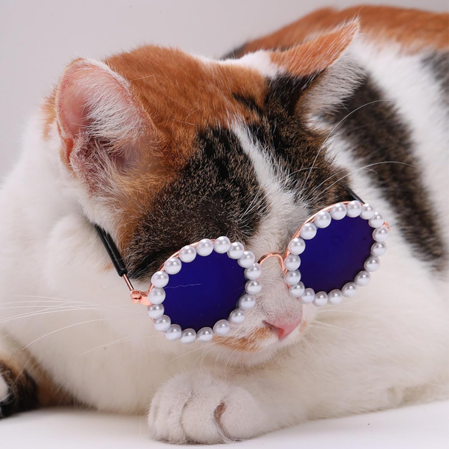 Round pearl sunglasses accessory with blue lenses and black arms