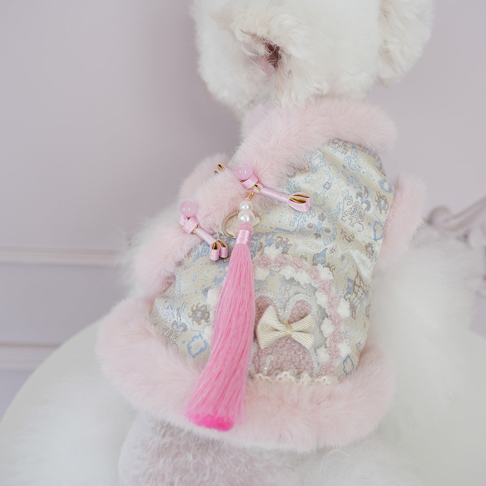 Pink and blue patterned pet jacket with white faux-fur collar, tassel and bow charms