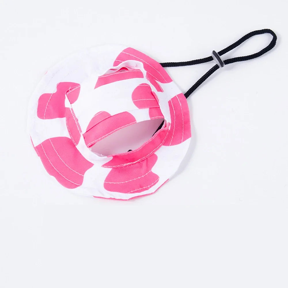 Adjustable pet bucket sun hat in white and pink pattern with chin strap and ear-hole openings