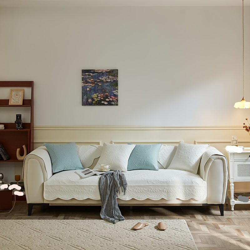 Light sofa cover with scalloped edge, draped over a non-slip loveseat-style surface