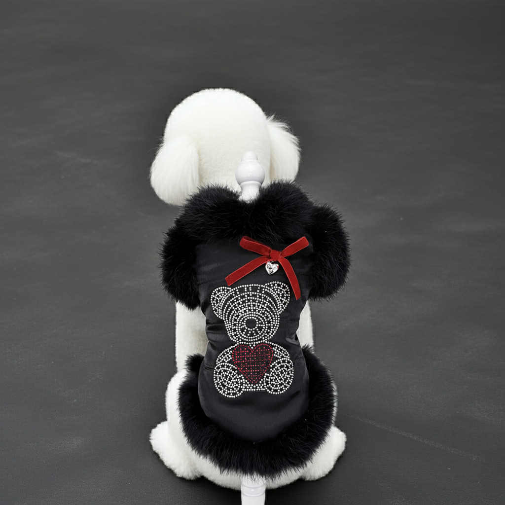 Black faux fur dog coat with white trim, red ribbon bow and heart rhinestone patch.