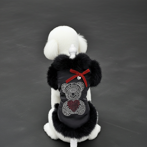 Black faux fur dog coat with red bow and rhinestone heart appliques, white trim.