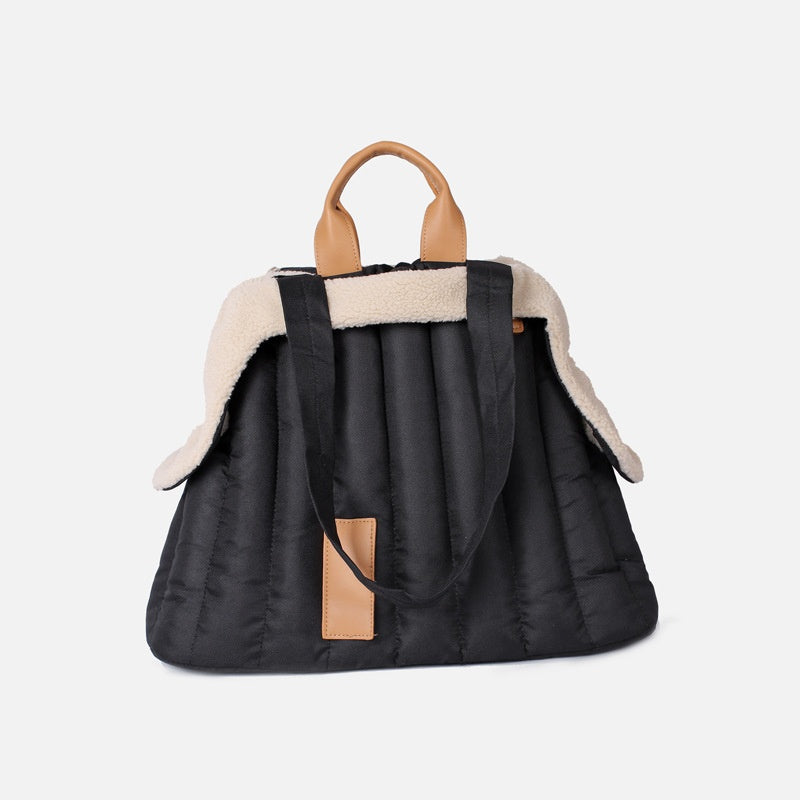 Black quilted pet shoulder bag with beige fleece trim and tan leather-look handle