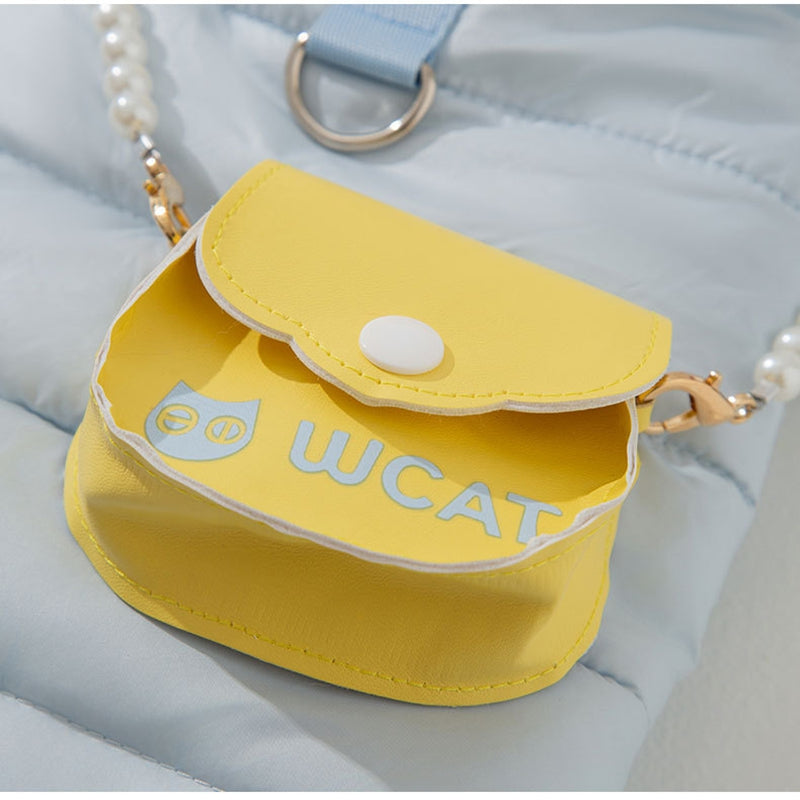 Yellow accessory pouch with pearl strap attached to light blue puffer pet outfit