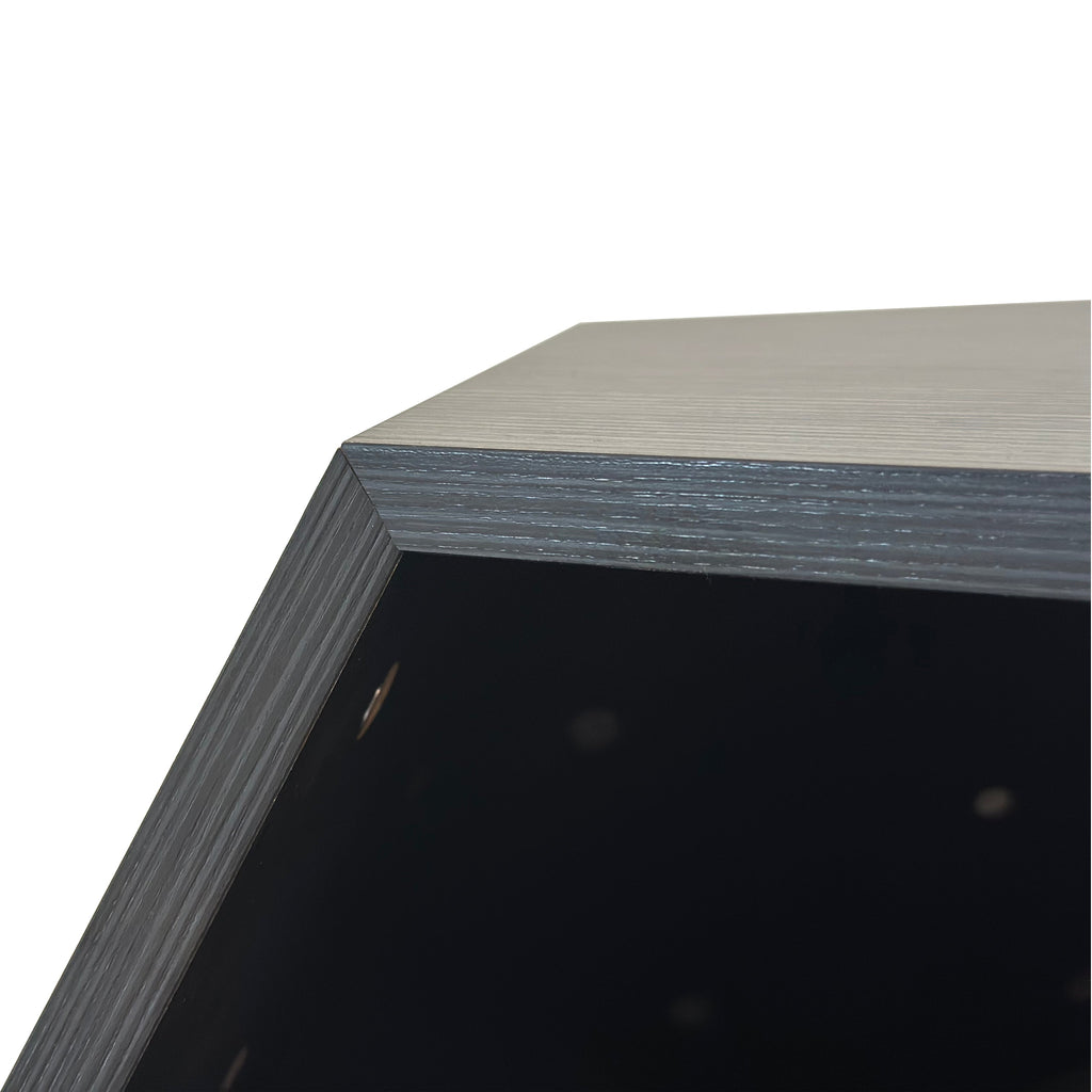 Close-up of dark gray MDF top surface and interior edge of hexagon cat bed