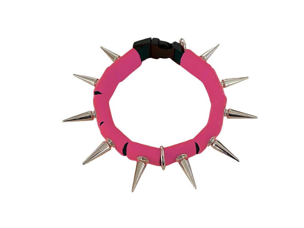 Coyote collar pink fabric ring with silver spikes and metal clasp at back.