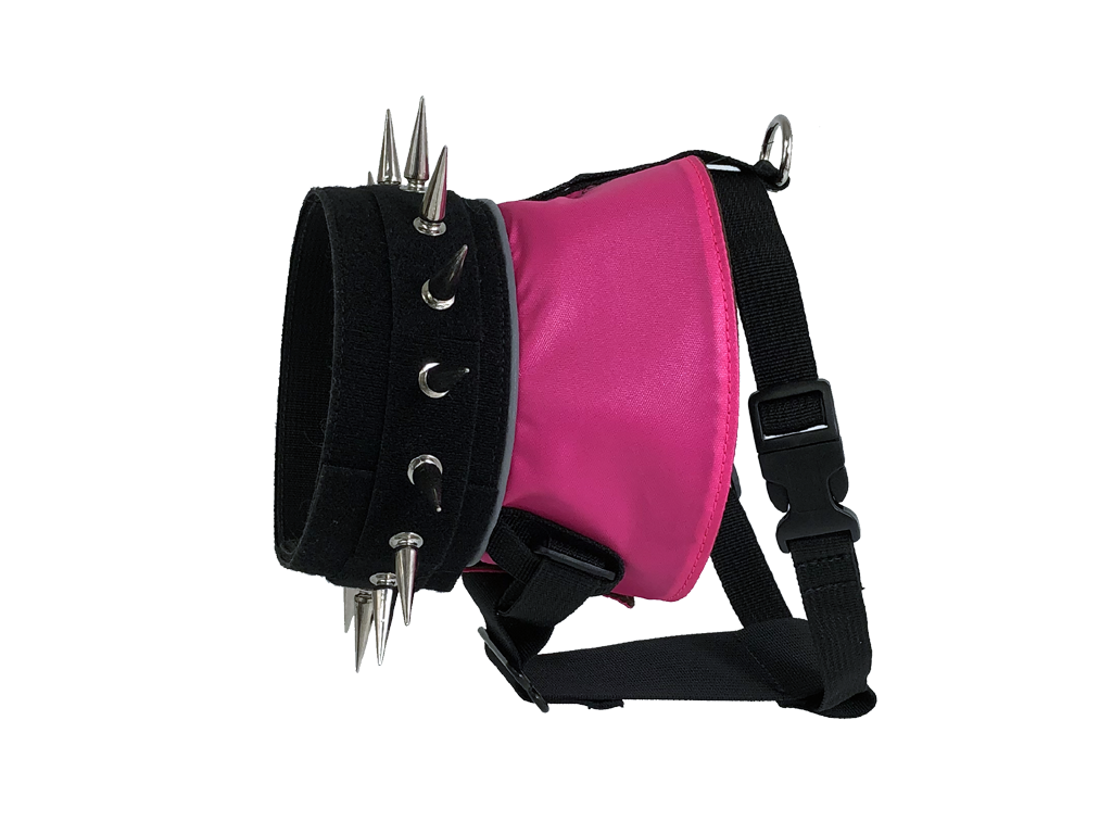 Neon pink dog harness with black webbing, metal spikes, and adjustable strap