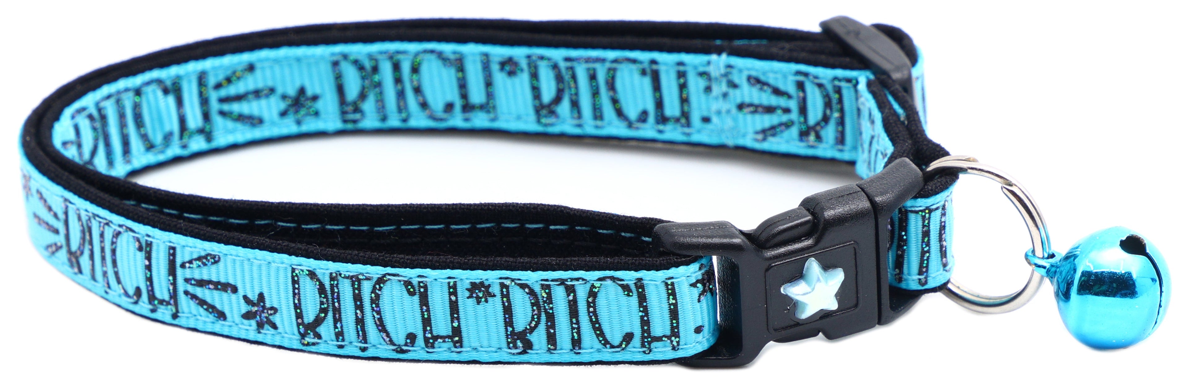 Blue fabric cat collar with black buckle, star emblem and small blue bell