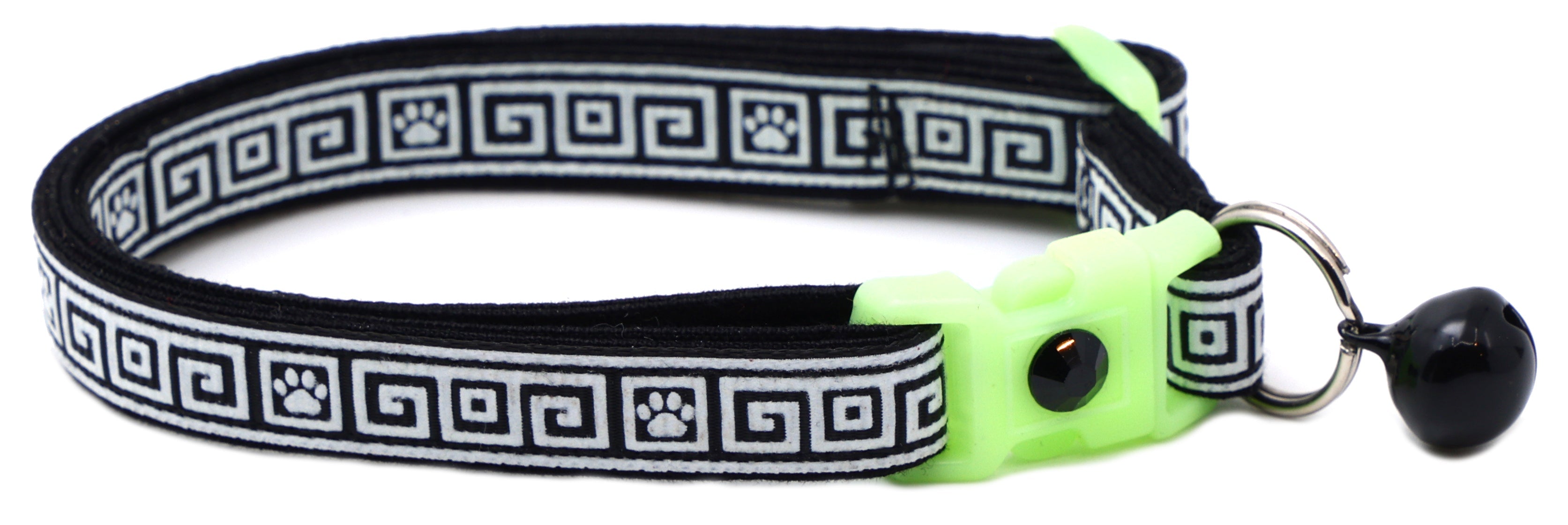 Black patterned cat collar with lime breakaway insert and black bell with silver paw charm