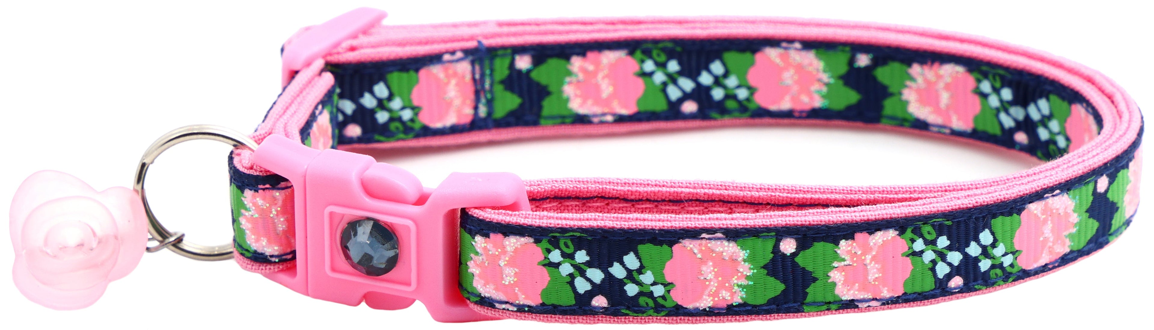 Navy floral cat collar with pink buckle and dark gem, pink bell charm, metal D-ring