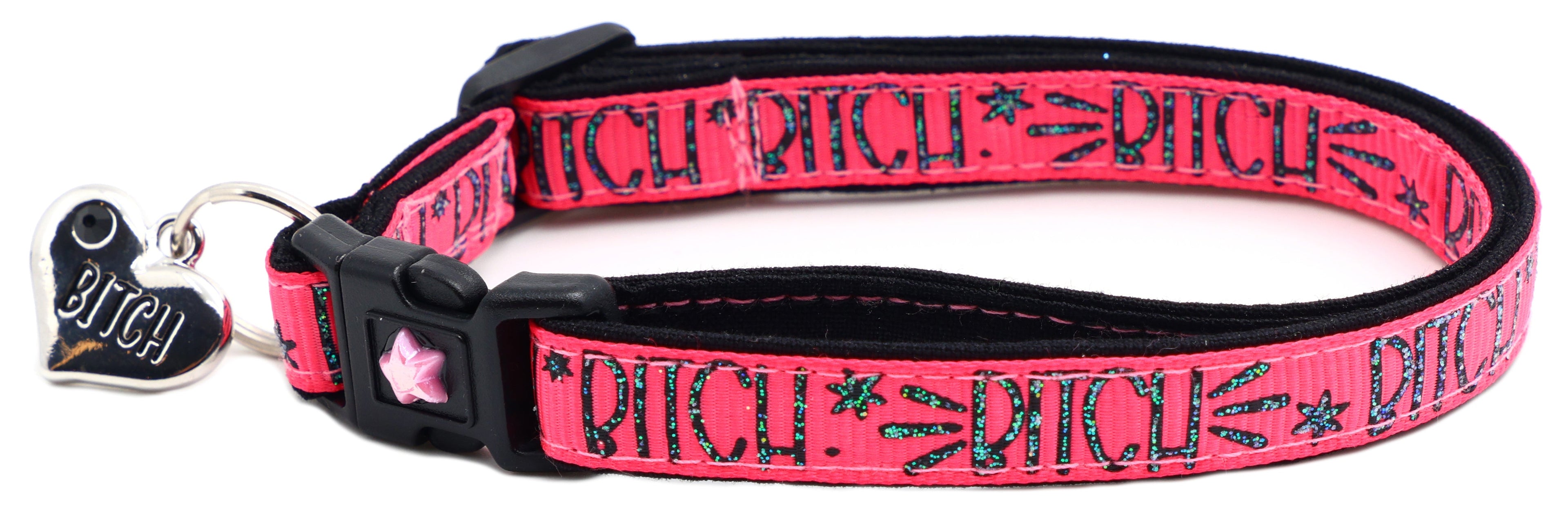 Red fabric cat collar with black buckle, star emblem and pink bell