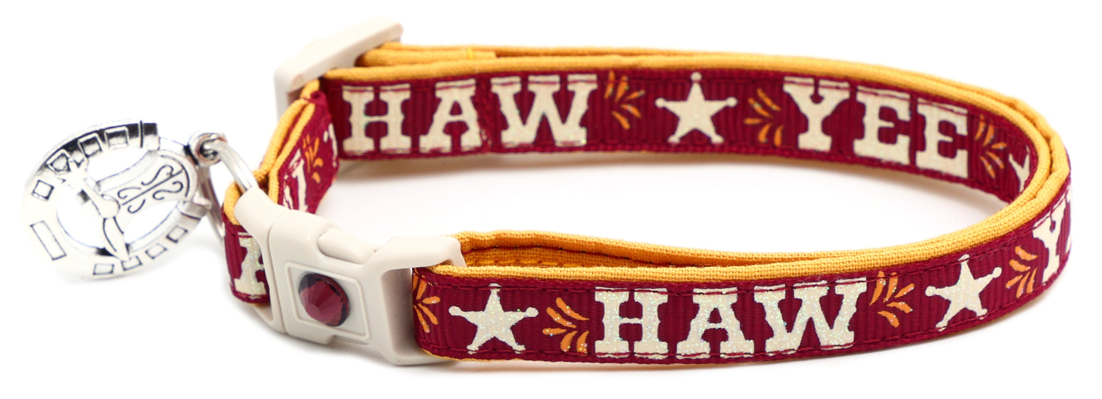 Red breakaway pet collar with orange trim, white buckle, “YEE HAW” star print