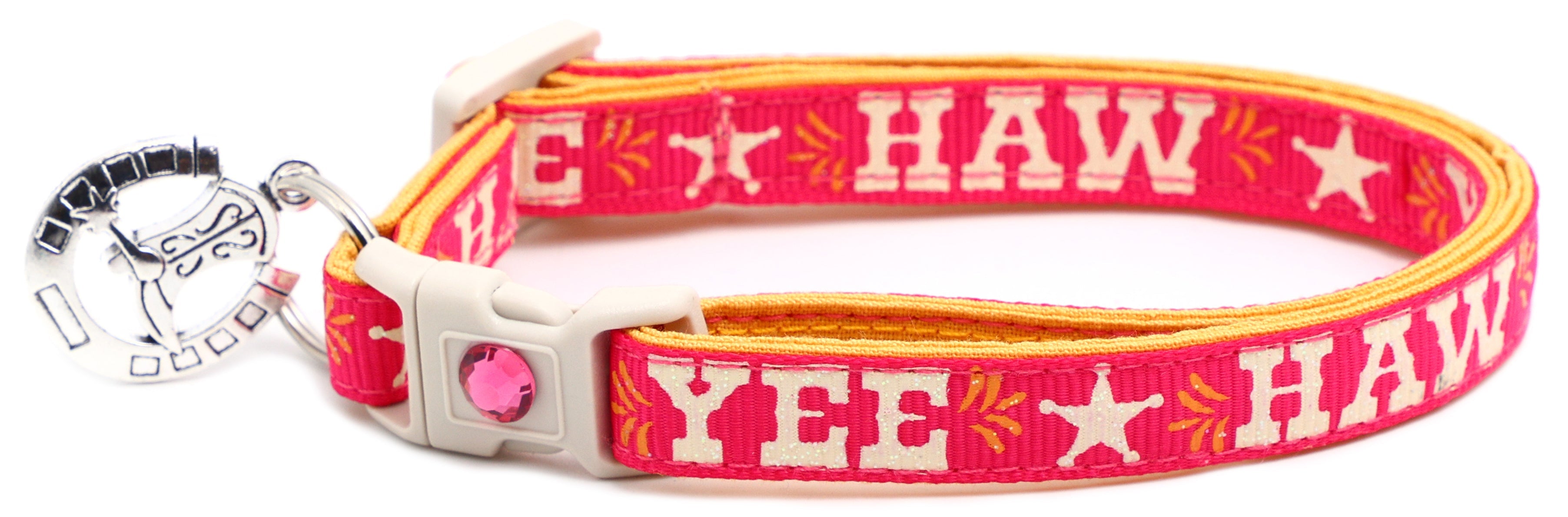 Pet breakaway collar with hot pink fabric, HA W pattern, white buckle, silver bell tag