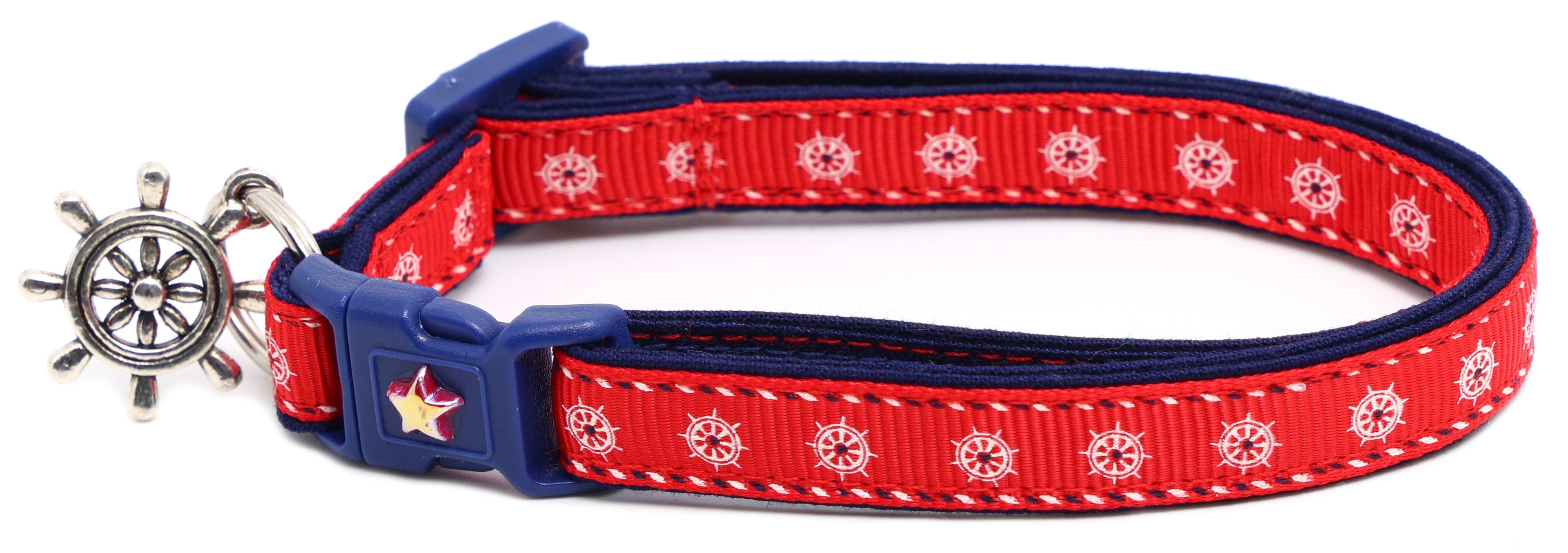 Red ships wheel breakaway cat collar with navy trim; ship wheel charm and star badge buckle.