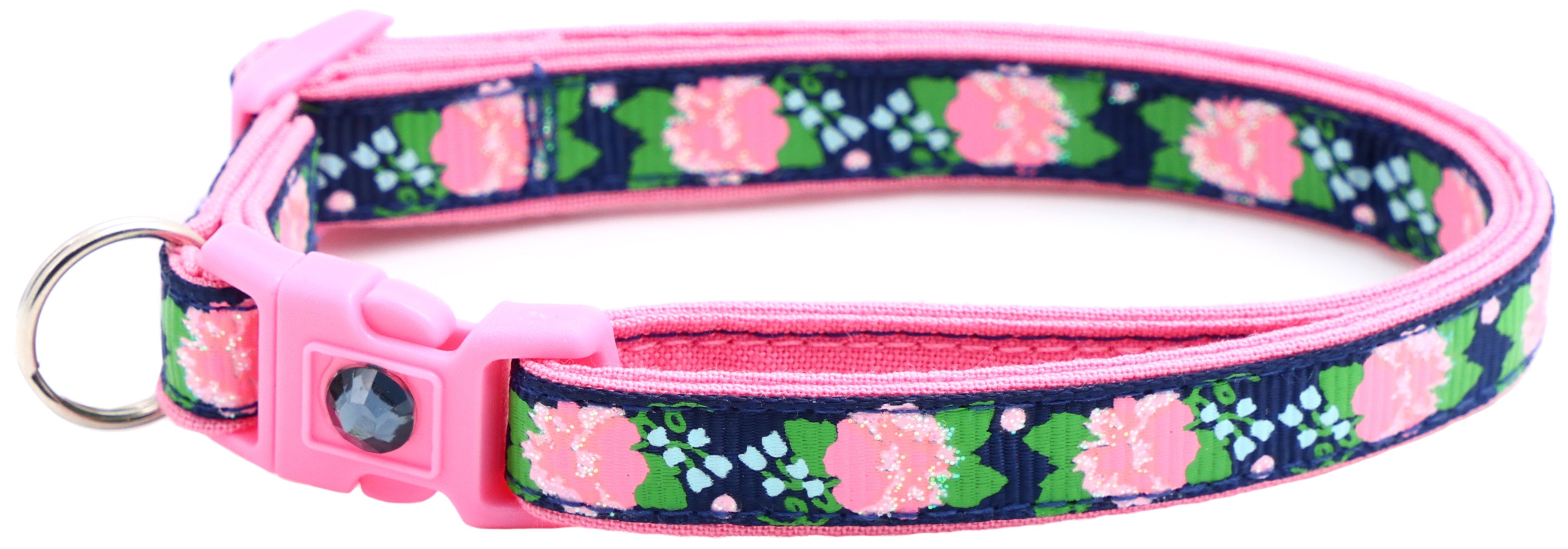 Pink-trim cat collar with navy floral pattern, pink buckle and dark gem, metal D-ring