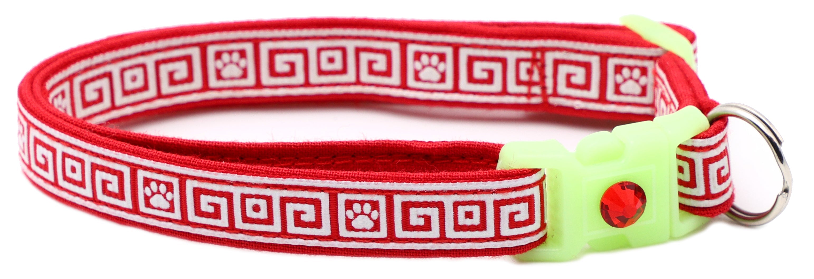 Red patterned cat collar with lime breakaway insert, light green ring, and red crystal charm