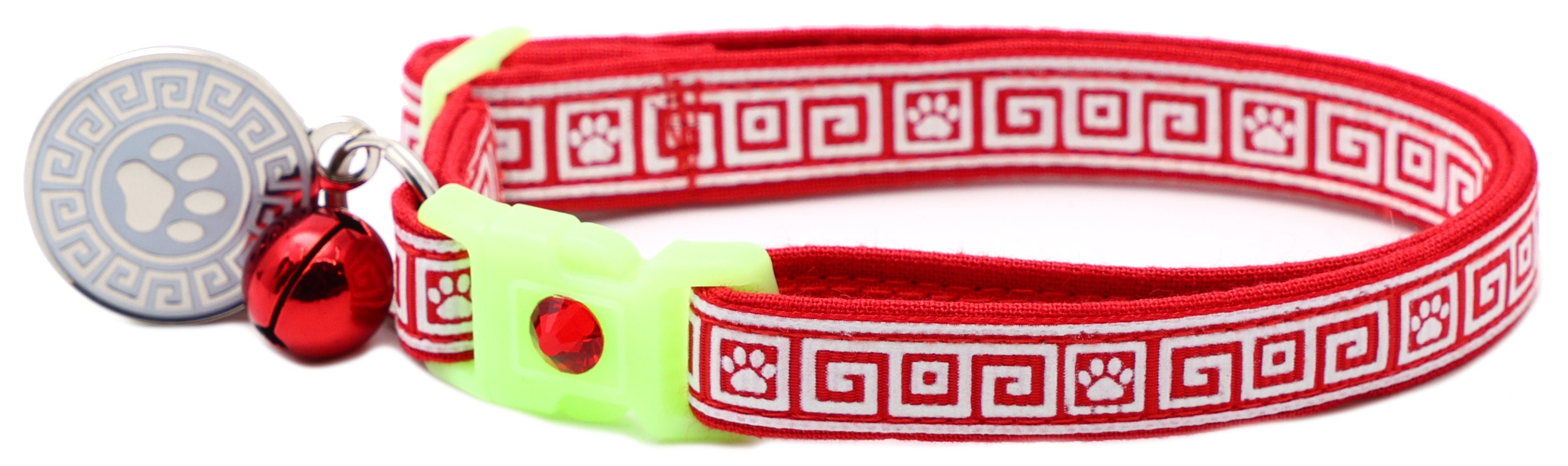 Red patterned cat collar with lime breakaway insert and red bell with silver paw charm
