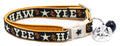 Dark navy breakaway pet collar with gold trim, white buckle, blue jingle bell charm