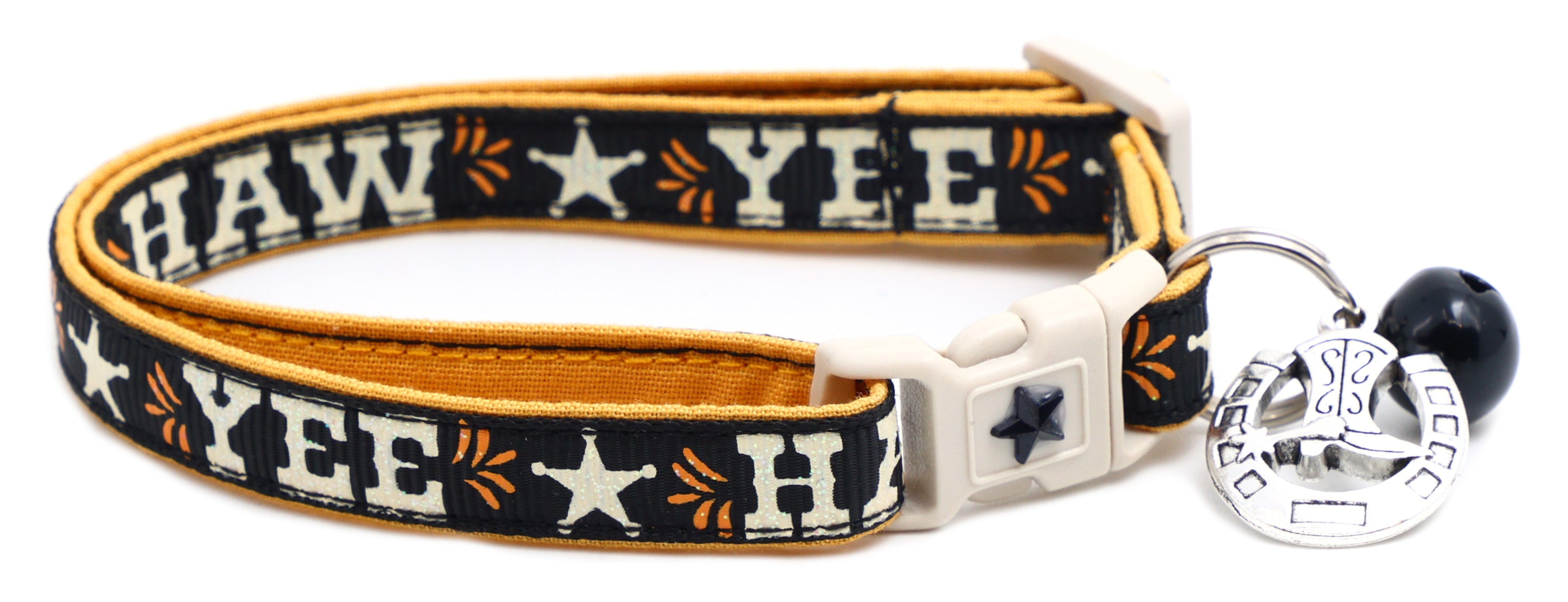 Dark navy breakaway pet collar with gold trim, white buckle, blue jingle bell charm